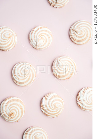 Sweet Meringue Cookies on Light Pink Background. Minimalistic Flat Lay Composition. Sweet Meringue Cookies on Light Pink Background. Minimalistic Flat Lay Composition. 127933430