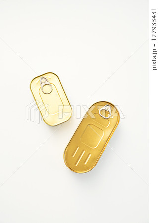 Two Golden Tin Cans with Pull Tabs on White. Canned Food and Sealed Packaging. 127933431