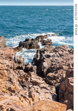 landscape of sea coast with rock in summer. wonderful weekend getaway in europe. textured coastline with blue sky above horizon 127933500