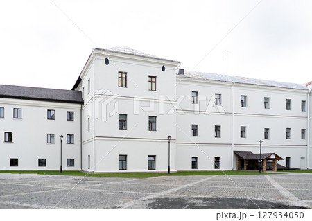 Modern building design house in concrete white with large windows and green lawn 127934050