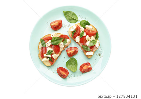 Tasty sandwich with mozzarella cheese, tomatoes and basil on plate isolated on white background. Caprese 127934131