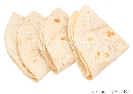 A stack of folded flour tortillas isolated on white background, perfect for tacos, wraps, burritos, or any fresh homemade Mexican dish A stack of folded flour tortillas isolated on white background, perfect for tacos, wraps, burritos, or any fresh homemade Mexican dish 127934306