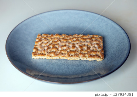 One piece of crunchy crispbread on a plate 127934381