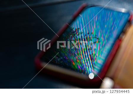 Spectrum blur reflection in glossy surface of smartphone 127934445