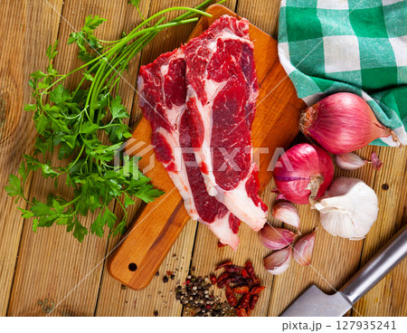 Image of raw veal with greens and spice before cooking 127935241