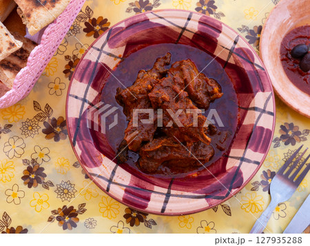 Dish of Tunisian cuisine is tajine. Baked lamb meat cooked in fragrant gravy with vegetables Dish of Tunisian cuisine is tajine. Baked lamb meat cooked in fragrant gravy with vegetables 127935288