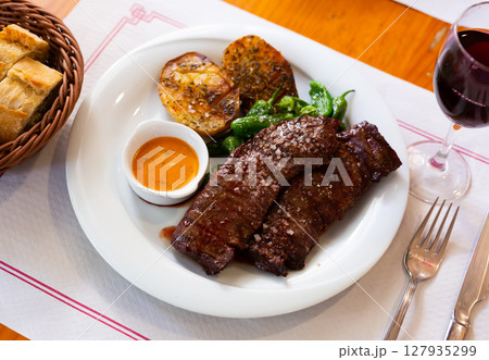 Grilled flank steaks with potatoes, jalapenos and chimichurri sauce Grilled flank steaks with potatoes, jalapenos and chimichurri sauce 127935299