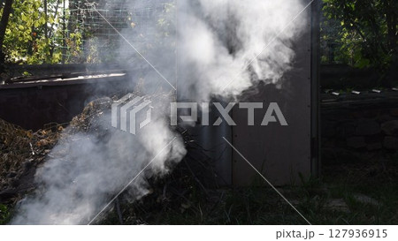Smoke background outdoors over pile of dried branches firewood 127936915