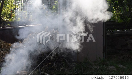 Smoke background outdoors over pile of dried branches firewood 127936916