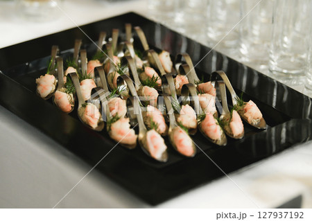 Shrimps with dill. Small canapes at a wedding Shrimps with dill. Small canapes at a wedding 127937192