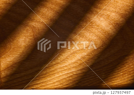 A close-up view of beautifully grained wood reveals rich, warm tones and smooth textures. 127937497