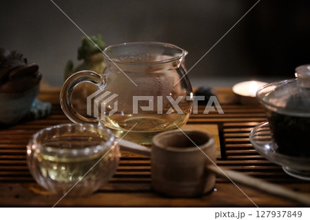 Traditional tea ceremony setup with glass teapot and cup Traditional tea ceremony setup with glass teapot and cup 127937849