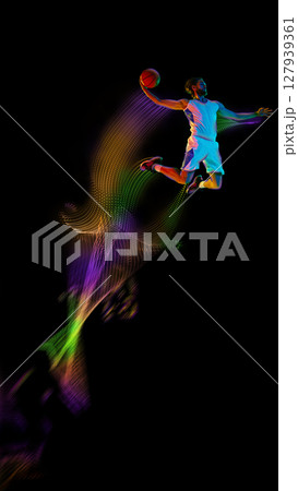 Basketball player dunking with glowing trail, futuristic slam dunk motion art. Poster, flyer 127939361