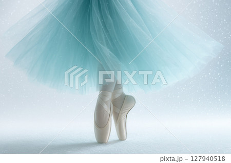 Graceful Ballet Dancer En Pointe in Icy Blue Tulle Skirt amid Gentle Falling Snow 127940518