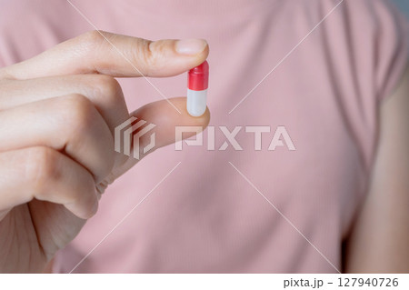 Close up woman hand holding vitamins and biological supplements. 127940726