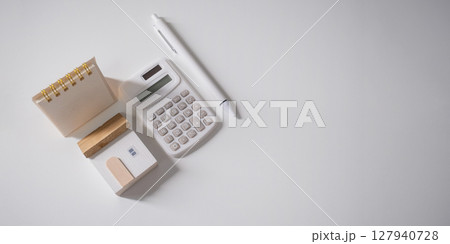Home loan interest payment appointment. Calendar, house model, calculator and pen on the white table with copy space. Home loan interest payment appointment. Calendar, house model, calculator and pen on the white table with copy space. 127940728