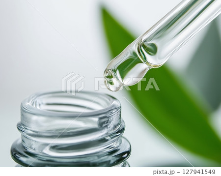 Glass dropper releasing clear Glass dropper releasing clear 127941549