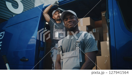 Portrait of Multiethnic Workers Standing Outside of Logistics Retail Warehouse, Looking at Camera Portrait of Multiethnic Workers Standing Outside of Logistics Retail Warehouse, Looking at Camera 127941564