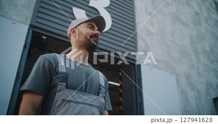 Logistics Distribution Warehouse: Employee Giving Cardboard Box with Online Orders to Loader Logistics Distribution Warehouse: Employee Giving Cardboard Box with Online Orders to Loader 127941628