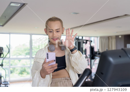 Non-binary person exercising in gym wearing sportswear Non-binary person exercising in gym wearing sportswear 127943109