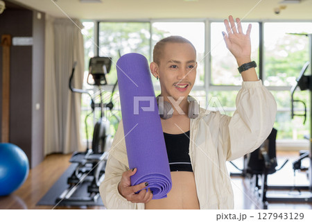 Non-binary person exercising in gym wearing sportswear Non-binary person exercising in gym wearing sportswear 127943129