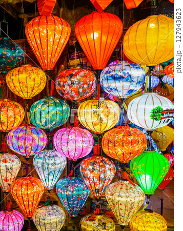 A kaleidoscope of traditional Vietnamese lanterns glowing in vivid colors during a market display A kaleidoscope of traditional Vietnamese lanterns glowing in vivid colors during a market display 127943623