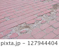 Broken Pavement Reveals Concrete Foundation Below 127944404