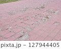 Damaged Red Brick Walkway Needs Immediate Repair 127944405