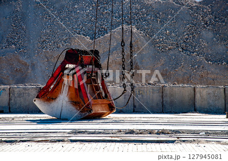 Cargo terminal for unloading clinker cargo and crane grab on chains Cargo terminal for unloading clinker cargo and crane grab on chains 127945081