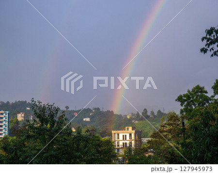 Rainbow in the mountains. Rainbow over a house in the mountains. Beautiful and cozy place. Rainbow in the mountains. Rainbow over a house in the mountains. Beautiful and cozy place. 127945973
