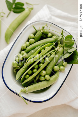 Fresh green peas in a white plate, healthy snack 127947406