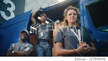 Team of Diverse Workers Standing Outside of Logistics Distribution Warehouse, Looking at Camera Team of Diverse Workers Standing Outside of Logistics Distribution Warehouse, Looking at Camera 127949340