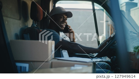 Delivery Truck Driver in Car Talking by Mobile Phone with Customer, Filling Out Papers Delivery Truck Driver in Car Talking by Mobile Phone with Customer, Filling Out Papers 127949614