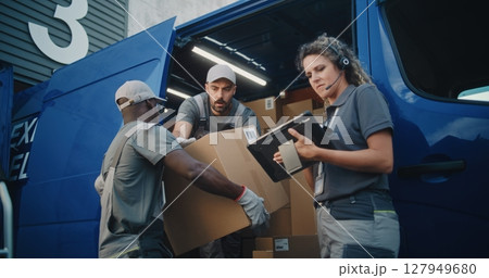 Multiethnic Workers Loading Cardboard Boxes with Online Orders, E-Commerce Goods in Delivery Truck 127949680