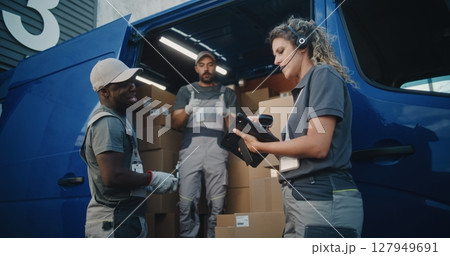 Employees Loading Delivery Truck with Cardboard Boxes. Female Manager Using Digital Tablet and Scanner Employees Loading Delivery Truck with Cardboard Boxes. Female Manager Using Digital Tablet and Scanner 127949691