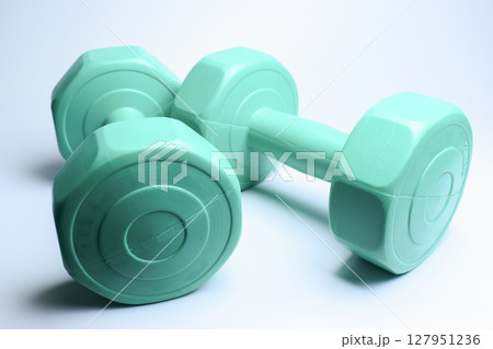 two green dumbbell on white background, object for exercise 127951236