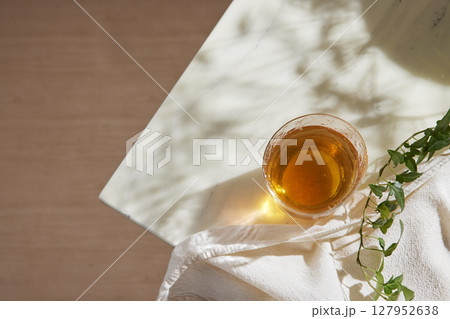 Minimal Aesthetic Beverages in Natural Light with Greenery. 127952638
