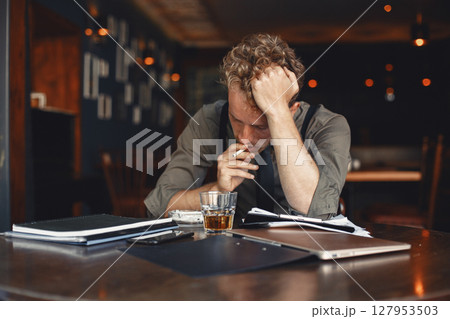 Man drinks whiskey. Businessman reads documents. Director in a shirt and suspenders. 127953503