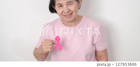Elderly woman with pink Ribbon for Pink October Breast Cancer Awareness month, May Women Health, August World Breastfeeding week, Nursing Mothers, Pregnancy and Infant Loss Remembrance, Stillbirth 127953600