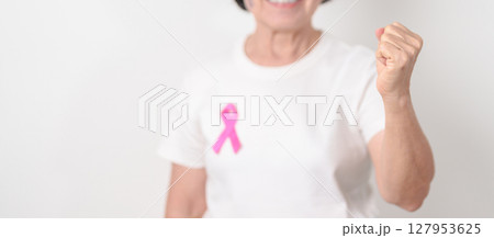Elderly woman with pink Ribbon for Pink October Breast Cancer Awareness month, May Women Health, August World Breastfeeding week, Nursing Mothers, Pregnancy and Infant Loss Remembrance, Stillbirth 127953625