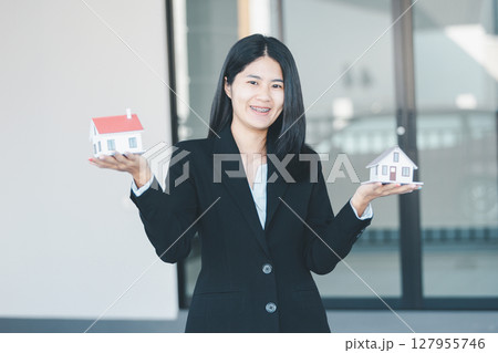 Woman hand hold key buy home model business concept involves sell financial management investment bank loan ownership income economy finance investments purchasing apartment blur background estate Woman hand hold key buy home model business concept involves sell financial management investment bank loan ownership income economy finance investments purchasing apartment blur background estate 127955746