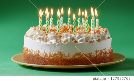 Birthday cake with candles on green backdrop 127955765