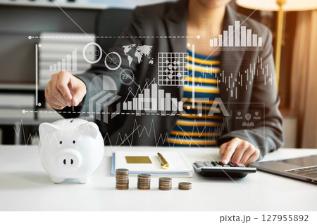 Business woman hand putting money coin into piggy bank with step of growing stack coins for saving money with virtual icon Business woman hand putting money coin into piggy bank with step of growing stack coins for saving money with virtual icon 127955892