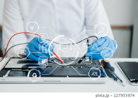 Electronics technician, electronic engineering electronic repair,electronics measuring and testing, repair and maintenance concepts.uses a voltage meter to check and upgrade in shop Electronics technician, electronic engineering electronic repair,electronics measuring and testing, repair and maintenance concepts.uses a voltage meter to check and upgrade in shop 127955974