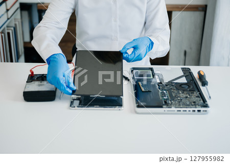 Electronics technician, electronic engineering electronic repair,electronics measuring and testing, repair and maintenance concepts.uses a voltage meter to check and upgrade in shop Electronics technician, electronic engineering electronic repair,electronics measuring and testing, repair and maintenance concepts.uses a voltage meter to check and upgrade in shop 127955982
