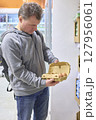 Person Carefully Examines Fresh Eggs At Grocery Store 127956061