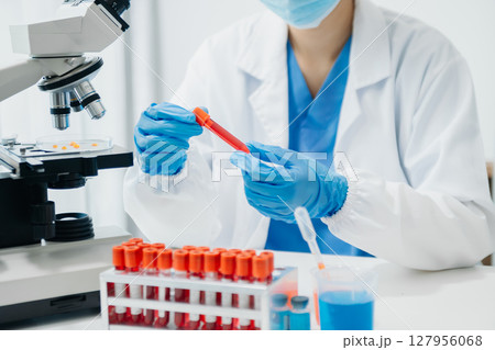 Modern medical research laboratory. female scientist working with micro pipettes analyzing biochemical samples, advanced science chemical laboratory Modern medical research laboratory. female scientist working with micro pipettes analyzing biochemical samples, advanced science chemical laboratory 127956068
