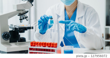 Coronavirus COVID 19 medical test vaccine research and development concept. Scientist in laboratory study and analyze scientific sample of Coronavirus antibody Coronavirus COVID 19 medical test vaccine research and development concept. Scientist in laboratory study and analyze scientific sample of Coronavirus antibody 127956072