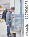 Student With Backpack Checks Grocery Cooler Display 127956073