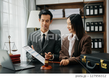 Business Asian people and lawyers discussing contract papers sitting at the table. Concepts of law, advice, legal services. Business Asian people and lawyers discussing contract papers sitting at the table. Concepts of law, advice, legal services. 127956312